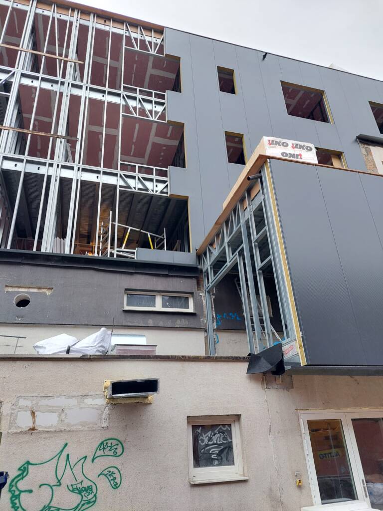 Montage d’une façade en ossature métallique ModuHome sur immeuble existant.